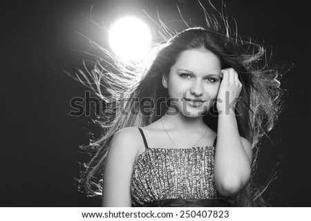 Girl with fluttering hair. Close-up portrait