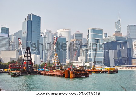 HONG KONG-SEPTEMBER, 2012: Barge building the new pier in the port of Hong Kong. View from the port of the island of Hong Kong\'s skyscrapers.