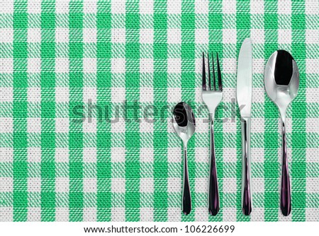 Checked cotton white and green dining cloth with silverware