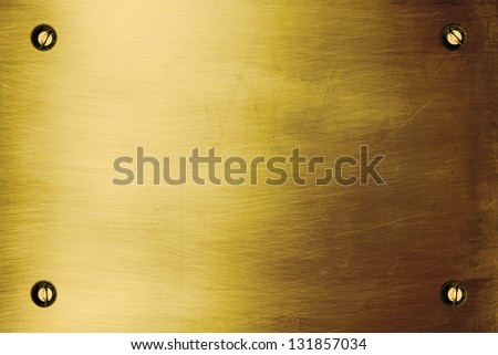 Shiny golden metallic plate with bolts