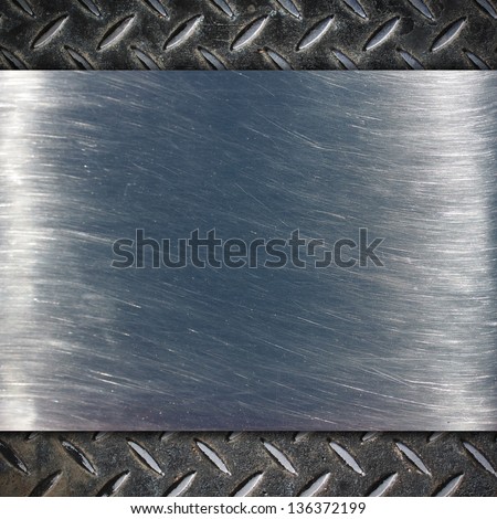 Metal plate over grid metal background