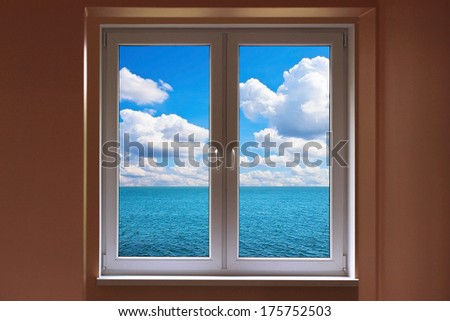Windows with view to sea with cloudy sunny sky