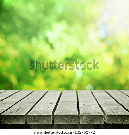 Wooden table in summer meadow for picnic