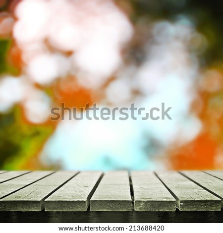 Wooden table near autumn meadow