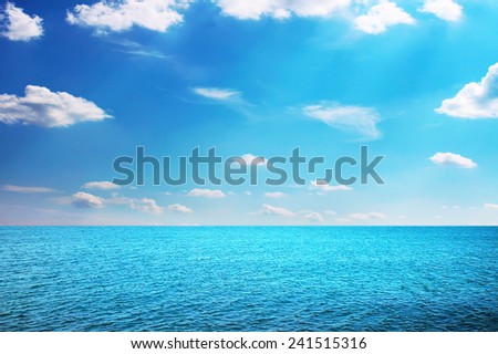 Summer sea with shiny sky with small clouds