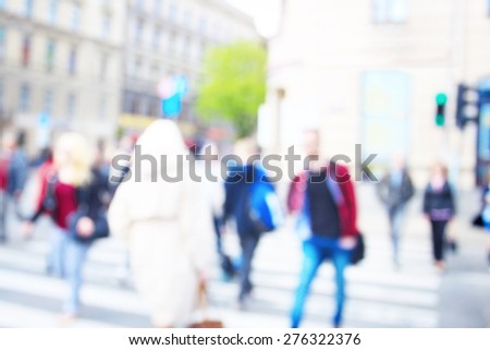 People in city at crosswalk after work going home. Blurred unrecognizable people in crowd