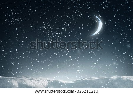 Winter flying snow in night over dark sky with moon and stars