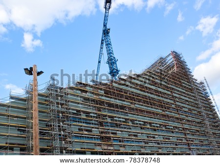 Building in the construction mode over blue sky