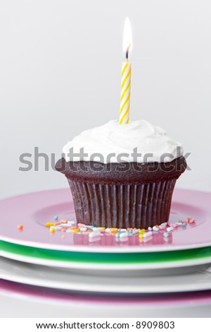 white vanilla frosted cupcake with candle