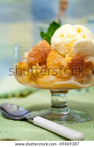A Bowl Of Peach Cobbler With Vanilla Ice Cream Against A Colorful Background