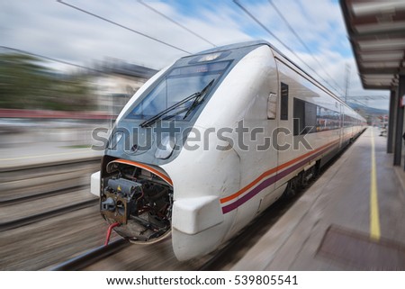 Train in motion with blurred background arriving at the station