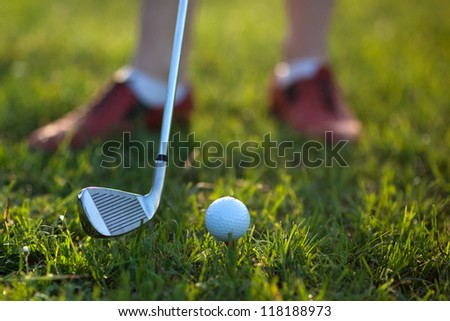 Golfer hitting the ball stick up close