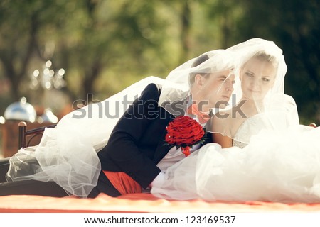 the bride and groom sitting and talking in your ear in nature. Wedding theme.