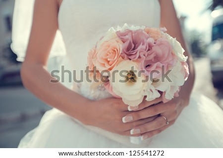 bridal bouquet of flowers in hands of the bride