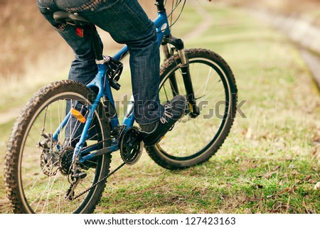 man rides a bicycle on mountain roads, photo closeup