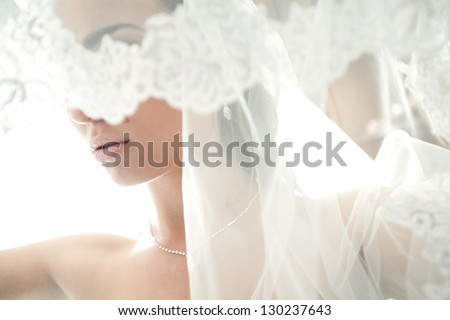 face of a beautiful bride hidden veil