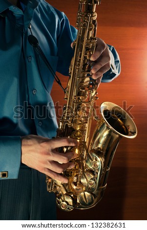 man playing jazz saxophone closeup