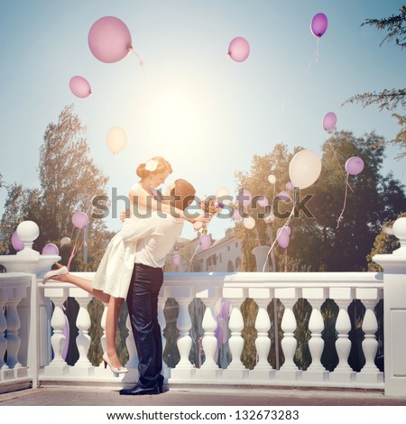 beautiful young couple man and woman hugging and kissing outdoors at the sea in a sunny day beautiful young couple man and woman hugging and kissing outdoors at the sea in a sunny day