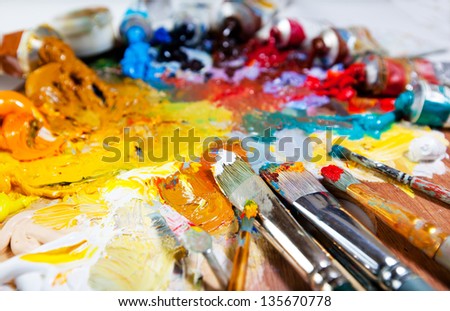 Art palette with oil paints and brushes. theme with paint brushes and palette