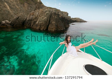 young beautiful female model lying on the deck of a yacht at sea. woman resting on the water