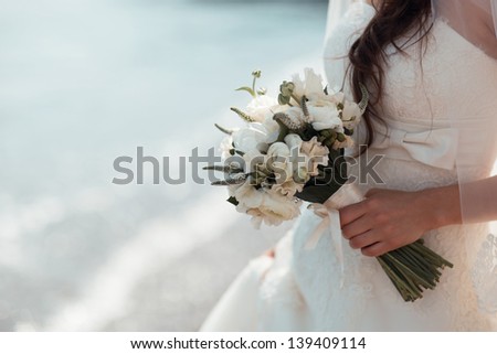 beautiful bridal bouquet of white roses in the hands of the bride