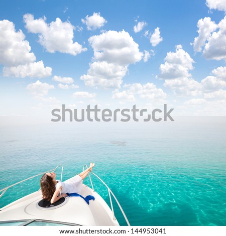 Young Sexy Woman Lies In White Dress Enjoying Clouds In The Sky On Yacht At The Sea