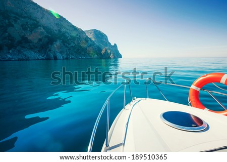 Private boat floats near the mountains. Luxury Lifestyle. Traveling on a yacht.