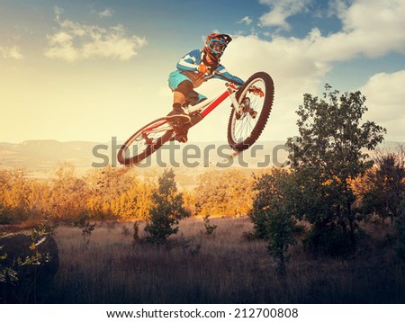 Man high jump on a mountain bike. Downhill cycling.