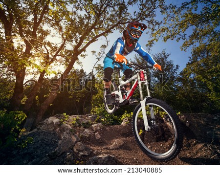 Cyclist riding a mountain bike downhill style. Extreme sports on a bicycle outdoors.