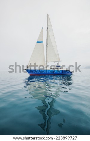 Sailing yacht sails on the sea.