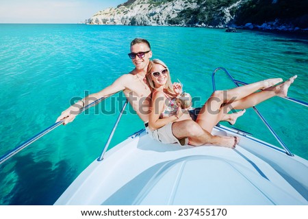 Couple resting on a yacht at sea. Luxury holiday vacation.