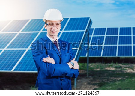Solar energy. Young business man in a suit near the solar panels to power plants.