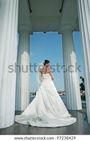 stock photo very beautiful bride in white wedding dress with columns