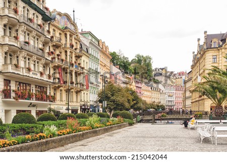 KARLOVY VARY, CZECH REPUBLIC - SEPTEMBER 15 2012:  Tourists relax in pedestrian area in historical spa town famous for elaborate, pastel architecture, hot mineral springs, medical spa facilities.