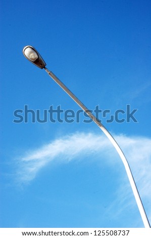 a street light pole with a blue sky background