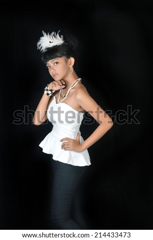 portrait of asian teenage girl dressing glamorous white and black on black background