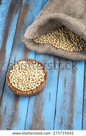 white beans with wooden bowl and sackcloth on the blue wooden table
