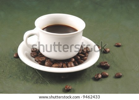 A cup of cafe and coffee beans