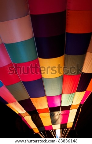 Colorful hot air balloon with flame and fire at night