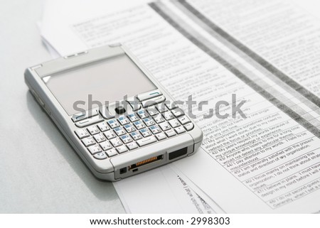 Mobile computer (organizer) on the documents at office table