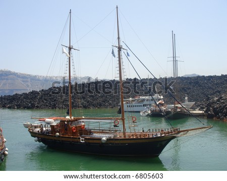 Beautiful Wood Boat near volcano of Santorini -Greece - stock photo