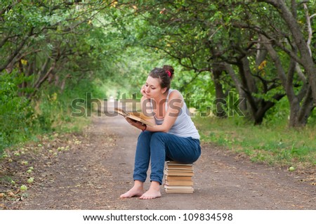 girl reading a book in the park