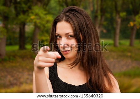 girl points a finger at the camera