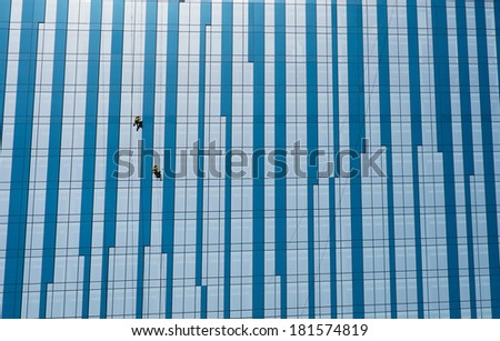 DUBAI, UNITED ARAB EMIRATES - 3 MARCH, 2014: Dubai skyscraper. Window washers wash windows. March  3, 2014 Dubai, UAE
