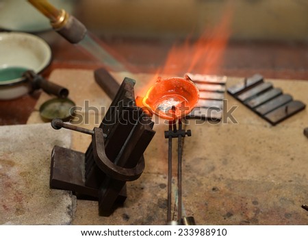 jeweler melts precious metal burner