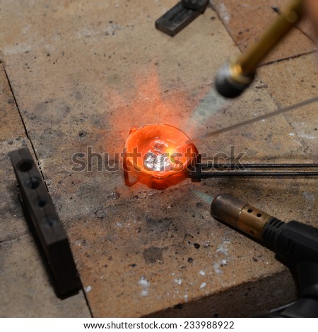 jeweler melts precious metal burner