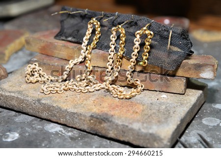 jeweler produces gold jewelry in the workshop