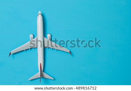 white airplane on a blue background, top view