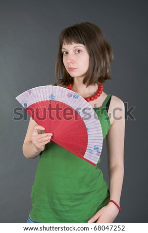 girl with a fan on a black background