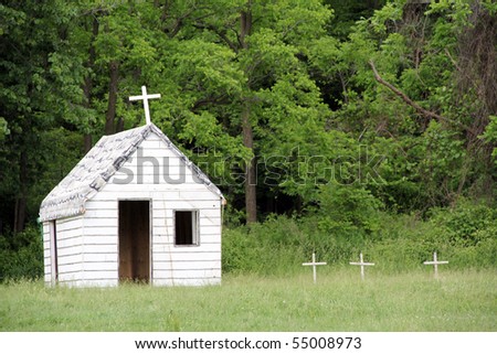 Small white church with white crosses